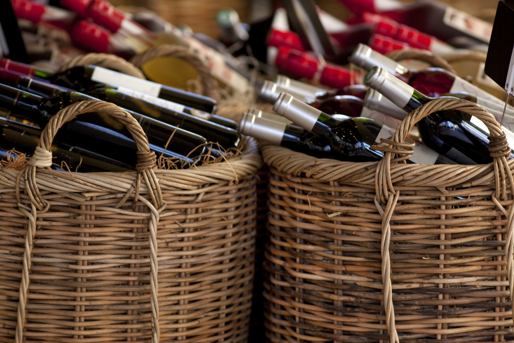 Red wine bottles in baskets