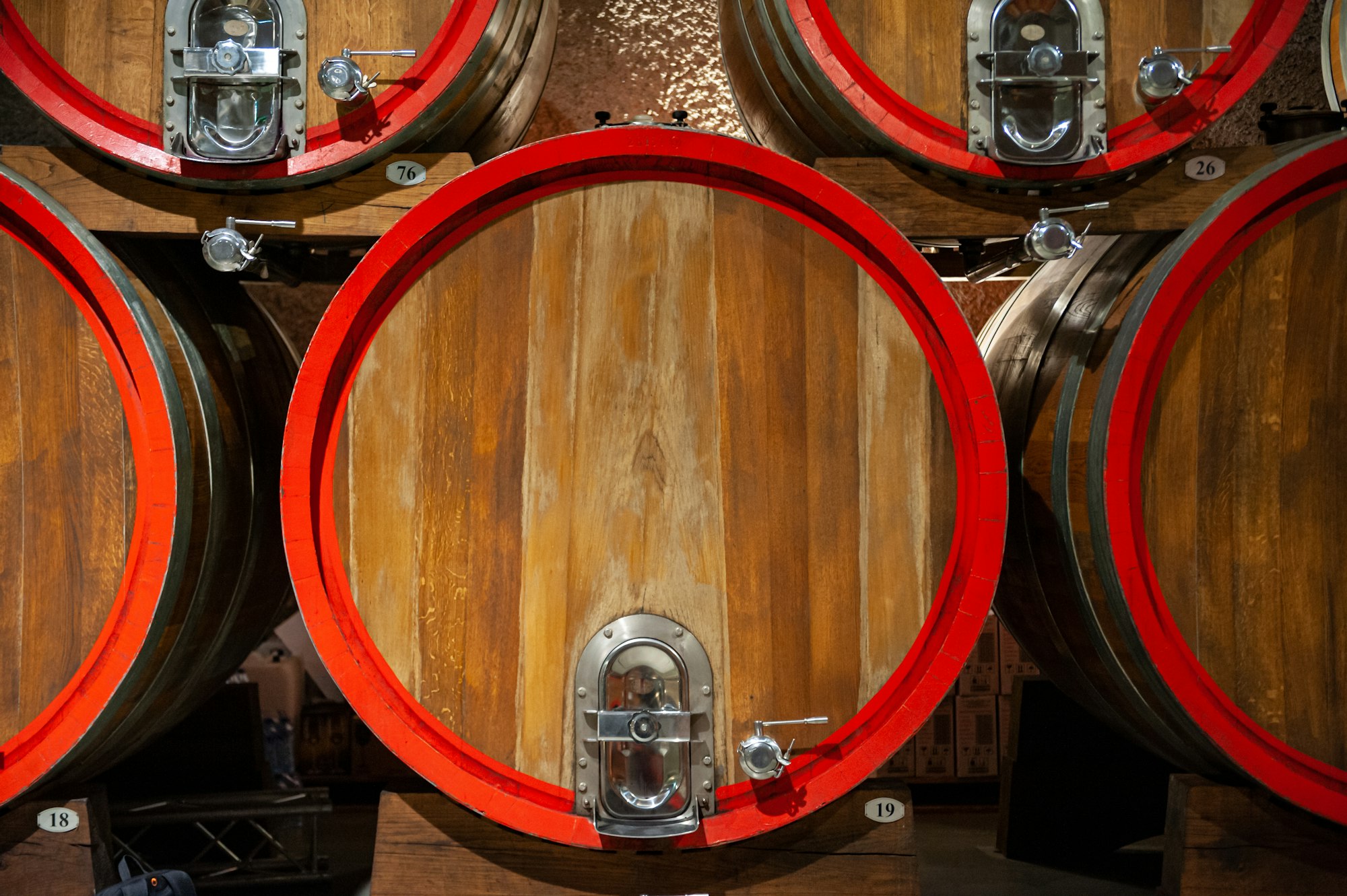 Rows of wooden wine barrels in a cellar