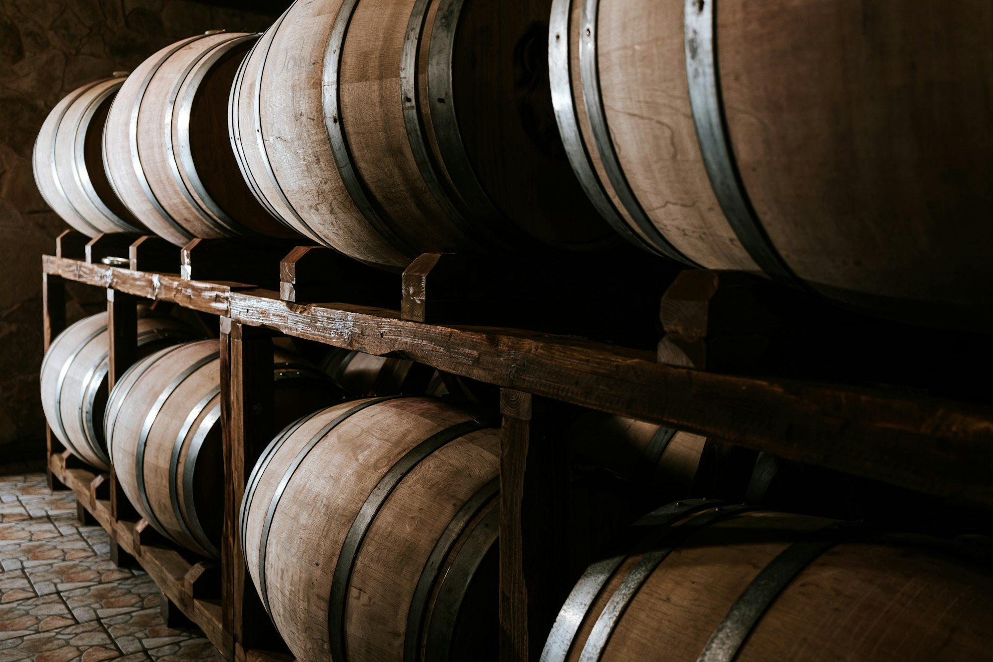 Wine wooden barrels in the cellar of a winery